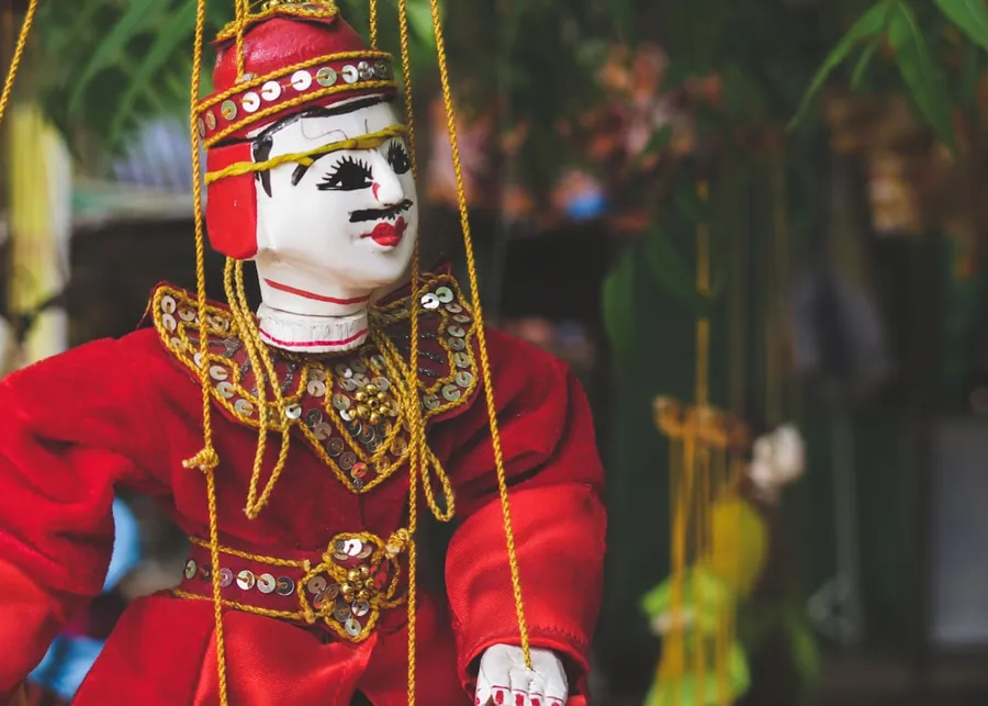 Ilustrasi mimpi betara indra — white and red poppet toy