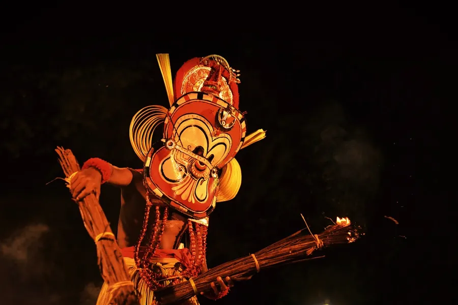 Ilustrasi mimpi dursasana — man wearing full-face mask holding torch with both hands