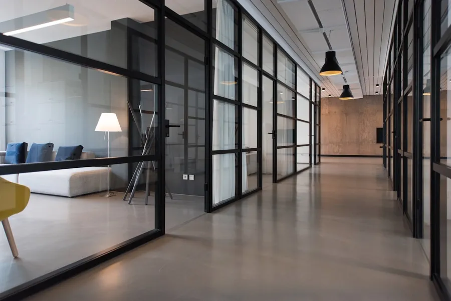 Ilustrasi mimpi kantor telkom — hallway between glass-panel doors