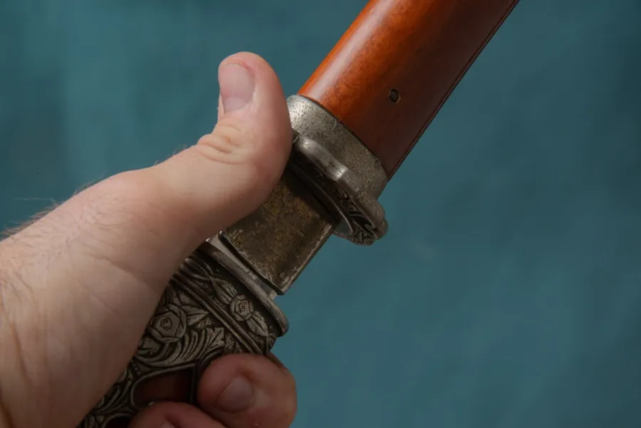 Ilustrasi mimpi keris — a hand holding a gun