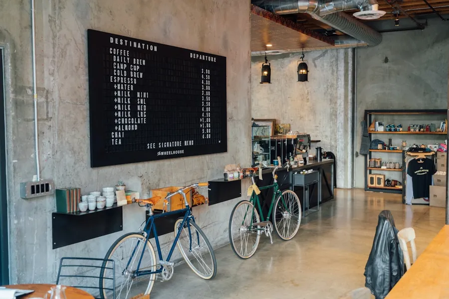 Ilustrasi mimpi membeli sepeda — two bikes parked beside wall inside room