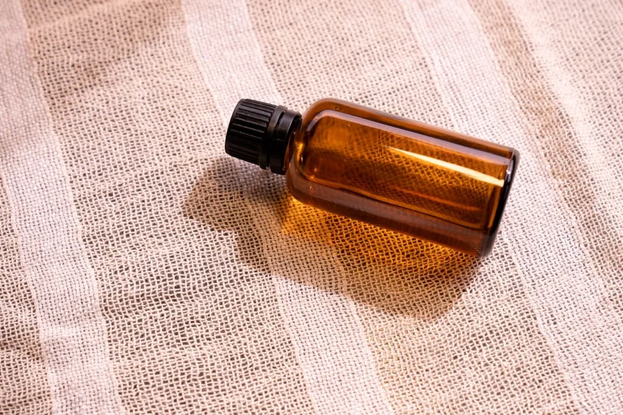 Ilustrasi mimpi minyak angin — a bottle of essential oil sitting on a cloth