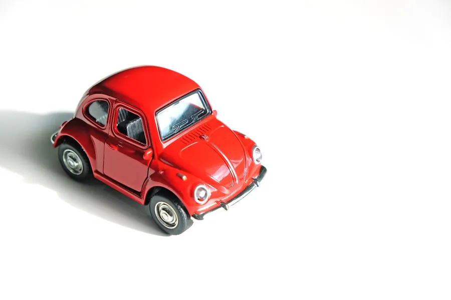 Ilustrasi mimpi mobil mainan — red coupe die-cast model