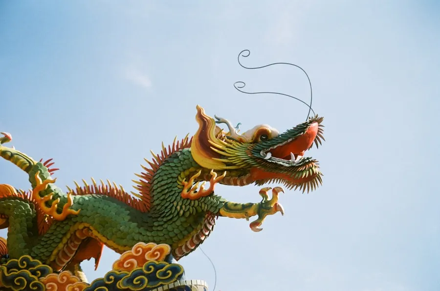 Ilustrasi mimpi naga — a dragon statue on top of a building