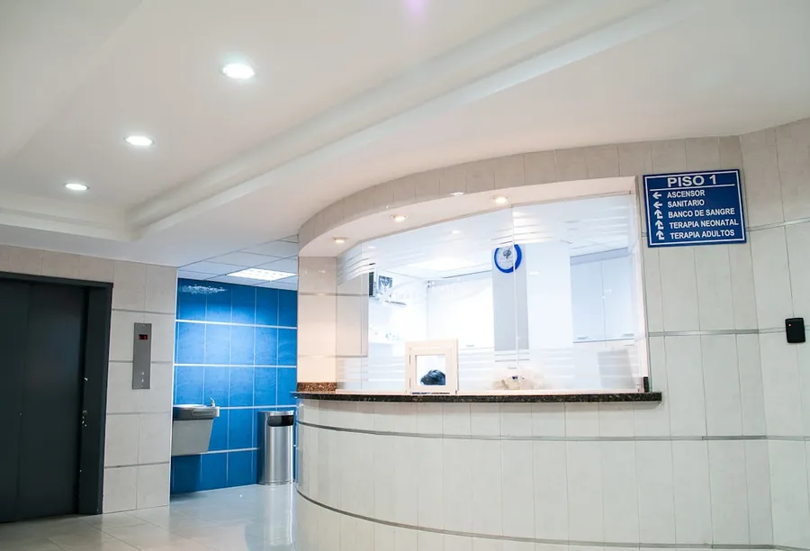 Ilustrasi mimpi rumah sakit — hospital lobby reception with signage