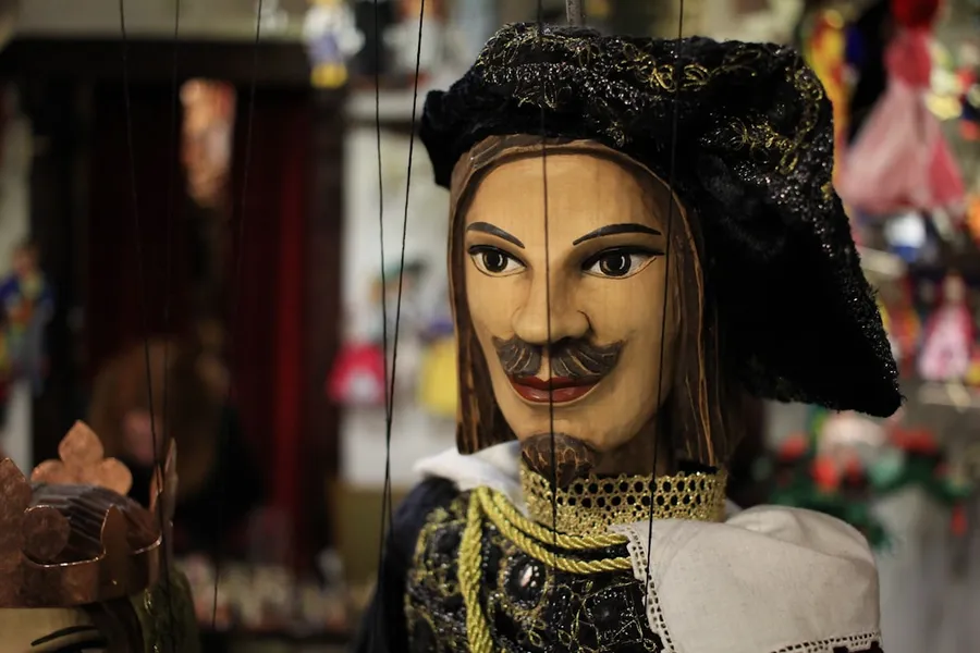 Ilustrasi mimpi siti sundari — a close up of a puppet of a man with a mustache