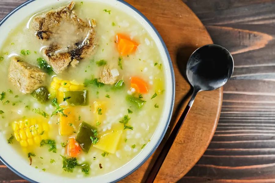 Ilustrasi mimpi soto ayam — a bowl of soup with a spoon