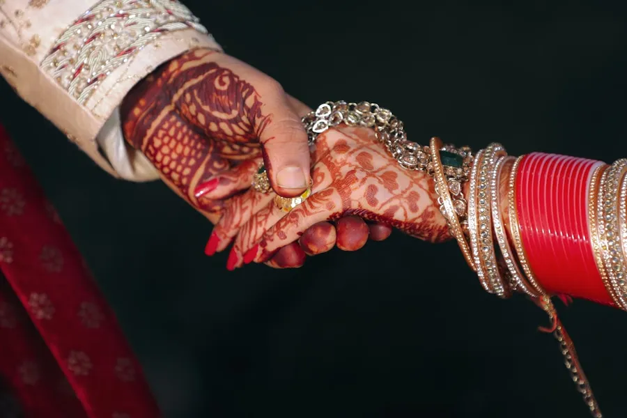 Ilustrasi mimpi suami istri — person wearing gold bracelet and gold bracelet