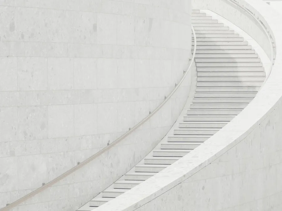 Ilustrasi mimpi tangga — a man riding a skateboard down a set of stairs