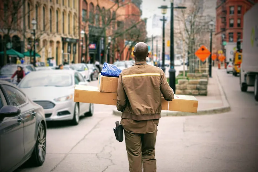 Ilustrasi mimpi tukang pos — man in brown jacket beside car