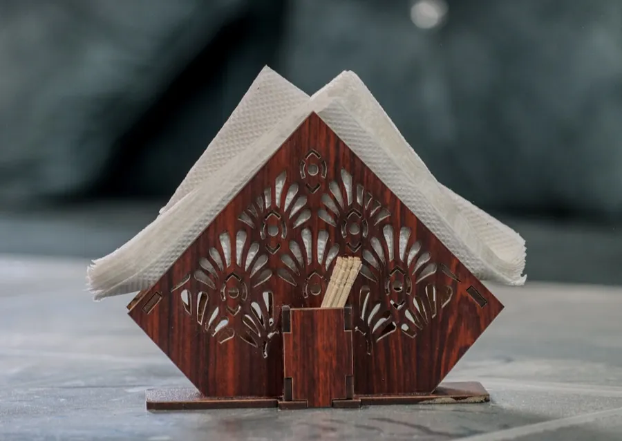 Ilustrasi mimpi tusuk gigi — A miniature house made out of wood on a table